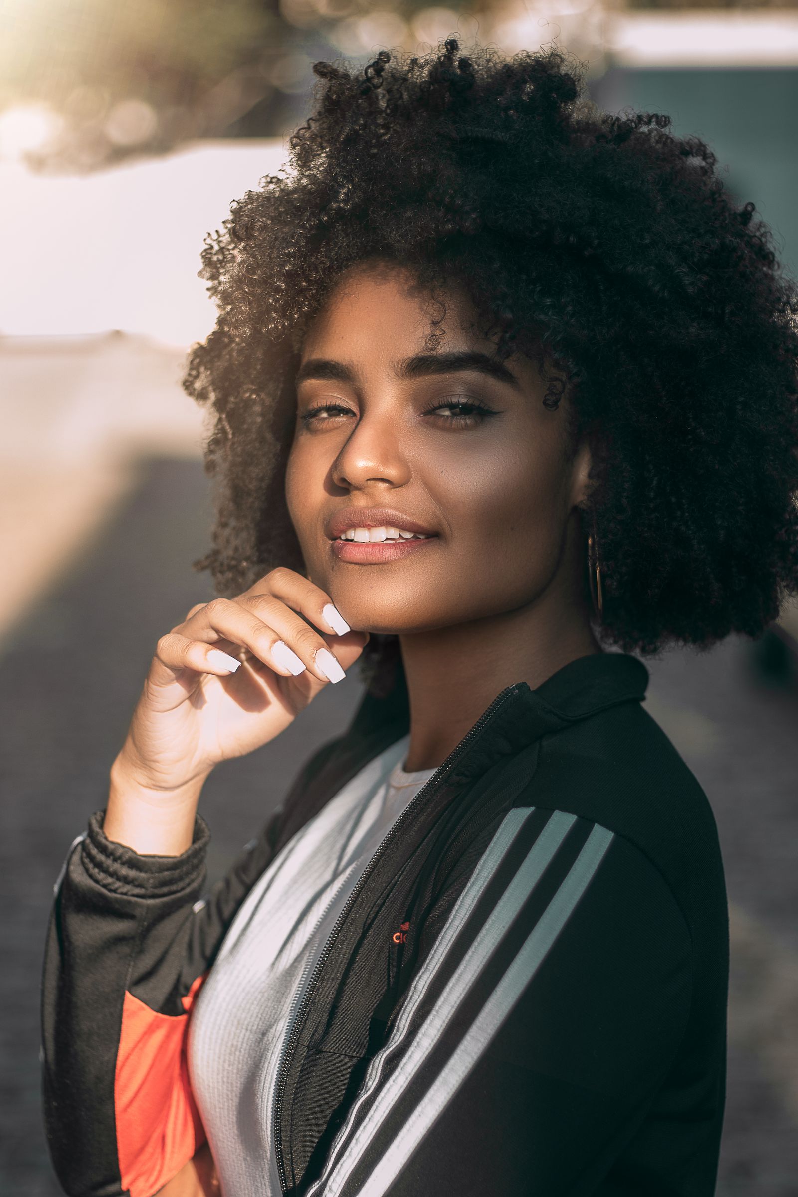 An African professional photographed outdoors in warm evening light